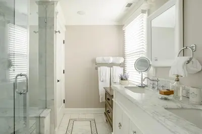 a white bathroom with a shower and a sink at Luxury Stay In Expansive Historical Home in North Haven