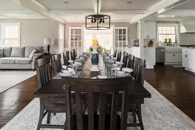 a dining room with a long table and chairs at Luxury Stay In Expansive Historical Home in North Haven