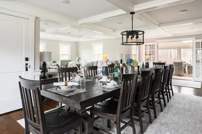 a dining room with a black table and chairs at Luxury Stay In Expansive Historical Home in North Haven