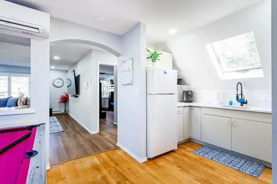 a kitchen with white cabinets and a pink refrigerator at Poconos Pines Retreat getaway near top attractions in Pocono Summit