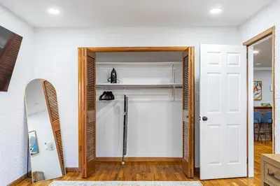 a bathroom with a white door and a mirror at Poconos Pines Retreat getaway near top attractions in Pocono Summit