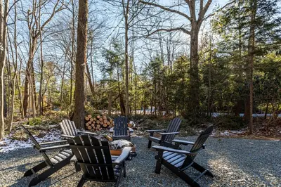 a group of chairs sitting around a fire pit at Poconos Pines Retreat getaway near top attractions in Pocono Summit