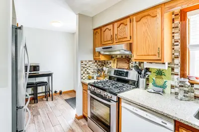 a kitchen with wooden cabinets and a stove top oven at Mtn Views and Private Yard Retreat in Cornwallville in Cornwallville