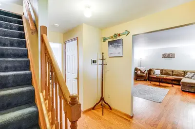 a living room with stairs and a couch at Mtn Views and Private Yard Retreat in Cornwallville in Cornwallville