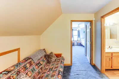 a bedroom with a couch and a sink in a room at Mtn Views and Private Yard Retreat in Cornwallville in Cornwallville