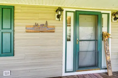a welcome sign on the side of a house with a door at Mtn Views and Private Yard Retreat in Cornwallville in Cornwallville