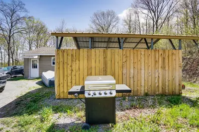 a barbecue grill in front of a wooden fence at Mtn Views and Private Yard Retreat in Cornwallville in Cornwallville