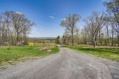 an empty road in the middle of a field at Mtn Views and Private Yard Retreat in Cornwallville in Cornwallville