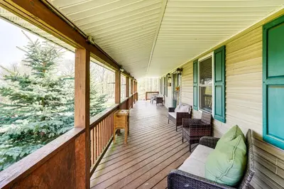 a porch of a house with chairs and windows at Mtn Views and Private Yard Retreat in Cornwallville in Cornwallville