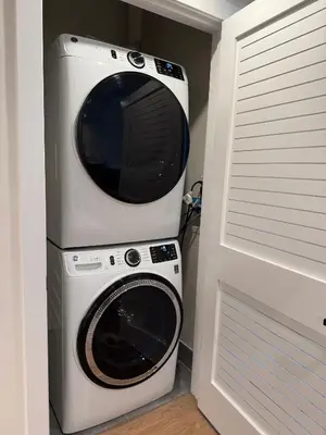 a microwave and a washing machine in a room at Hoboken Loft Hideaway - walk to PATH in Hoboken