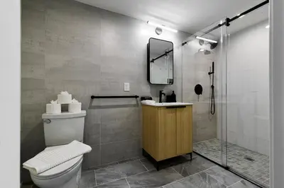 a bathroom with a toilet and a shower at Bright 3BR Loft • Hoboken Gem in Hoboken