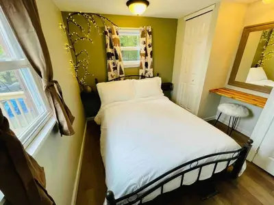 a small bedroom with a bed with a head board at High-View Catskills Cabin in Margaretville
