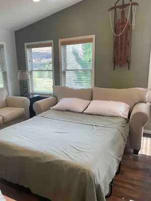a bedroom with a large bed and a couch at High-View Catskills Cabin in Margaretville