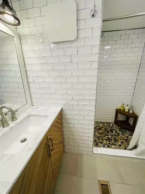a white bathroom with a sink and a shower at High-View Catskills Cabin in Margaretville