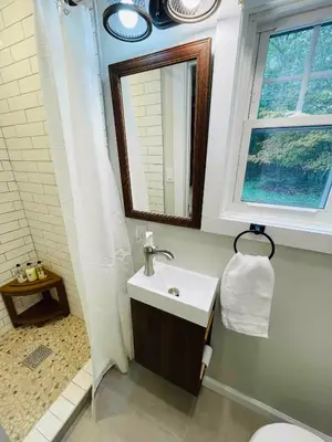 a bathroom with a sink and a shower at High-View Catskills Cabin in Margaretville