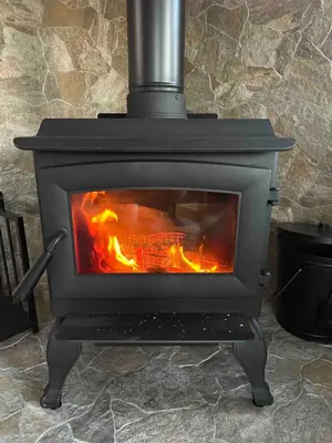 a stove with a fire inside of it at High-View Catskills Cabin in Margaretville
