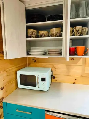 a microwave oven sitting on top of a kitchen counter at High-View Catskills Cabin in Margaretville