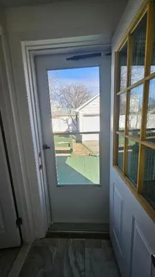 an open door with a view of a yard at The Heart of Hicksville House in Hicksville