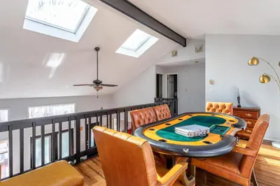 a dining room with a table and chairs at Twin Pines Retreat Hot Tub Theater Room Fire in East Stroudsburg