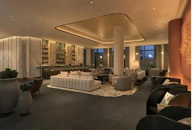 a lobby with white couches and tables and chairs at The Rhyland in Flushing
