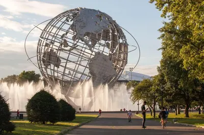 a large sculpture of a globe in front of a fountain at The Rhyland in Flushing