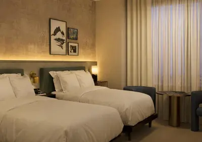 a hotel room with two beds and a window at The Rhyland in Flushing