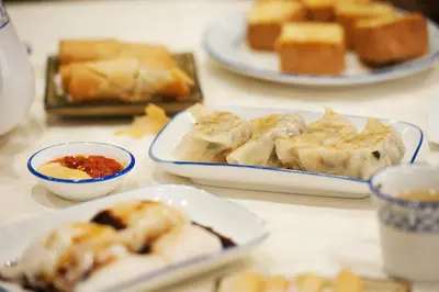 a table with plates of pastries and cups of food at The Rhyland in Flushing