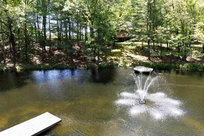a fountain in the middle of a pond at Catskill Estate epic views hot tub in Kingston