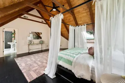 a bedroom with a canopy bed with a wooden ceiling at Catskill Estate epic views hot tub in Kingston