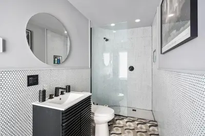 a bathroom with a sink and a toilet and a mirror at Catskill Estate epic views hot tub in Kingston