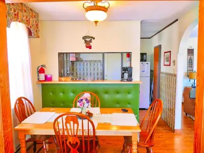 a dining room with a table and chairs and a kitchen at Lakefront Cabin Rental with Incredible Sunsets on Lake Wallenpaupack, Pennsylvania in Hawley