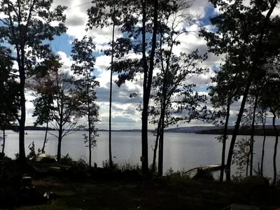 a view of a large body of water with trees at Rustic Cabin Beside the Great Sacandaga Lake in Northville, New York in Northville