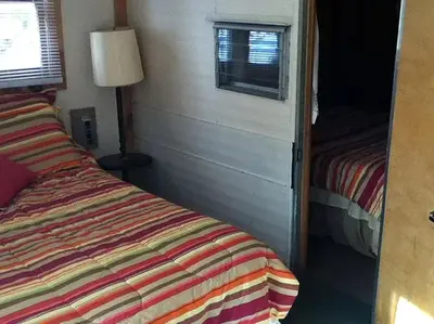 a small bedroom with a bed and a window at Rustic Cabin Beside the Great Sacandaga Lake in Northville, New York in Northville