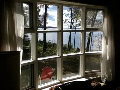 a room with a large window with a view at Rustic Cabin Beside the Great Sacandaga Lake in Northville, New York in Northville