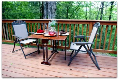 a table and two chairs sitting on a deck at Romantic Cottage Rental with Hot Tub Outside Woodstock, New York in Bearsville