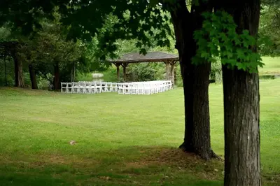 a gazebo with a wedding ceremony in a field at Secluded Cottage Rental with a Heated Pool in Red Hook for Family Getaways in New York State in Red Hook