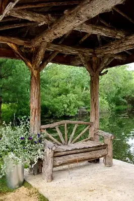 a wooden bench sitting under a gazebo with flowers at Secluded Cottage Rental with a Heated Pool in Red Hook for Family Getaways in New York State in Red Hook