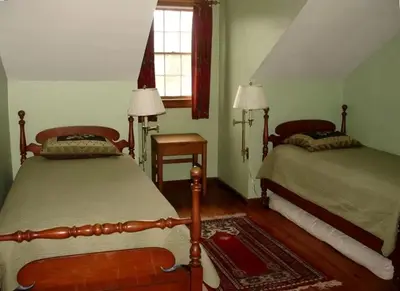 a bedroom with two beds and a window at Secluded Cottage Rental with a Heated Pool in Red Hook for Family Getaways in New York State in Red Hook
