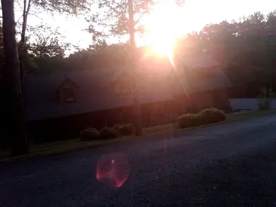 a house with the sun shining on a street at Bed and Breakfast Cabin for Weekend Getaway near Millbrook, New York in Dover Plains