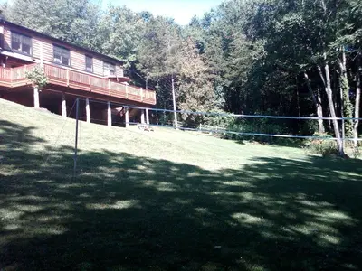 a large yard in front of a house with trees at Bed and Breakfast Cabin for Weekend Getaway near Millbrook, New York in Dover Plains