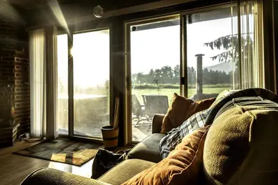 a living room with a couch and a large window at Rustic Cabin Rental with a Hot Tub near Windham, New York in Windham