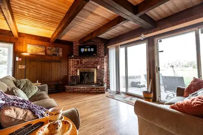 a living room with a couch and a fireplace at Rustic Cabin Rental with a Hot Tub near Windham, New York in Windham