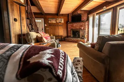 a living room with a couch and a fireplace at Rustic Cabin Rental with a Hot Tub near Windham, New York in Windham
