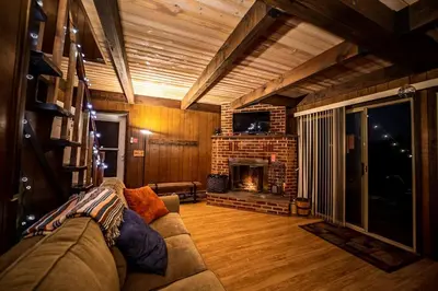 a living room with a couch and a fireplace at Rustic Cabin Rental with a Hot Tub near Windham, New York in Windham