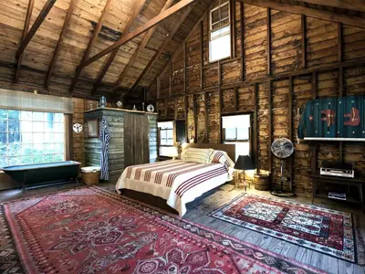 a bedroom with a bed in a wooden cabin at Secluded and Rustic Cabin Rental with Modern Amenities near Woodstock, New York in Willow