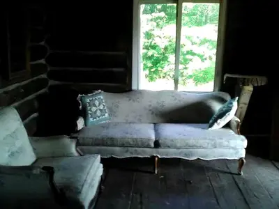 a couch sitting in a room with a window at Pet-Friendly Rustic Cabin on Grafton Mountain, New York in Johnsonville