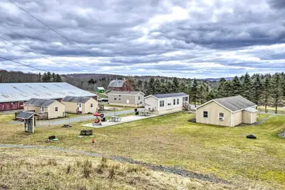 a group of houses in a field with trees at Remote Ski Rentals for a Gorgeous Pennsylvania Retreat in Pleasant Mount