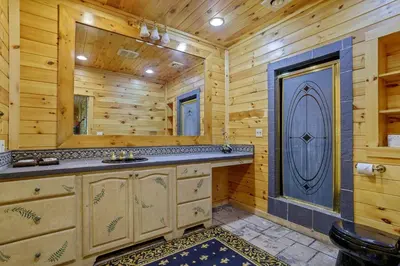 a log cabin bathroom with a sink and a mirror at Spacious Villa Rental with a Pool for a Large Group near Catskill Mountains, New York in Fishs Eddy