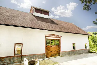 an old white church with a large wooden door at 27-Person Luxury Villa Rental in Hudson Valley, New York in Monroe