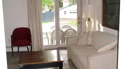 a living room with a couch and a table at Hilltop Cottage Rental Overlooking Creek near Albany in Upstate New York in Fly Creek